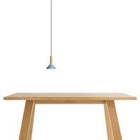 Light wood table with a minimalist design, complemented by a soft blue pendant lamp for a modern touch.