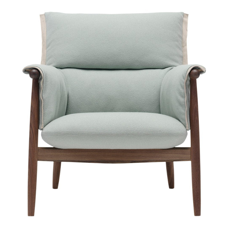 Light mint green upholstered armchair with wooden frame and cream-colored accent at the top. Modern and stylish design.