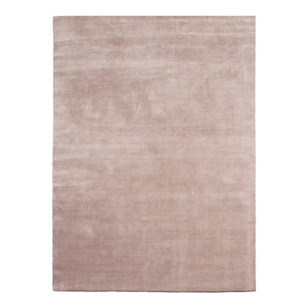 Soft blush pink area rug with a smooth, solid texture, perfect for adding warmth to any space.