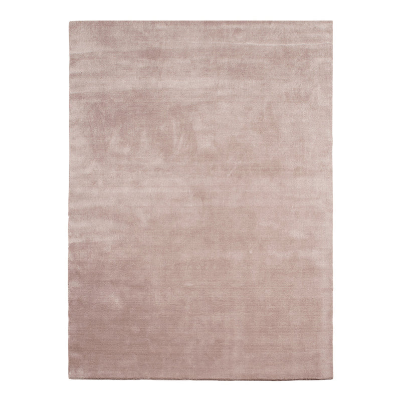 Soft blush pink area rug with a smooth, solid texture, perfect for adding warmth to any space.