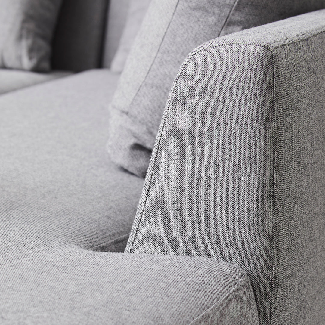 Gray fabric couch with a smooth texture and subtle, modern design elements. Perfect for minimalist spaces.