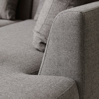 Gray textured fabric with a subtle pattern, showcasing clean lines and a modern design aesthetic.