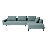 Modern L-shaped sofa in soft, muted teal fabric with clean lines and minimalist design. Perfect for contemporary spaces.