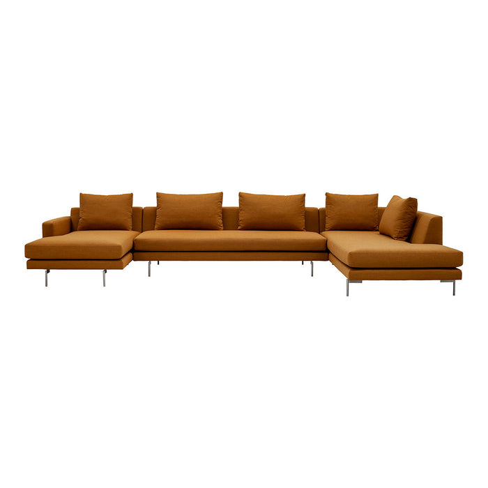 Angular sectional sofa in warm mustard yellow fabric with plush cushions and sleek silver legs. Ideal for modern decor.