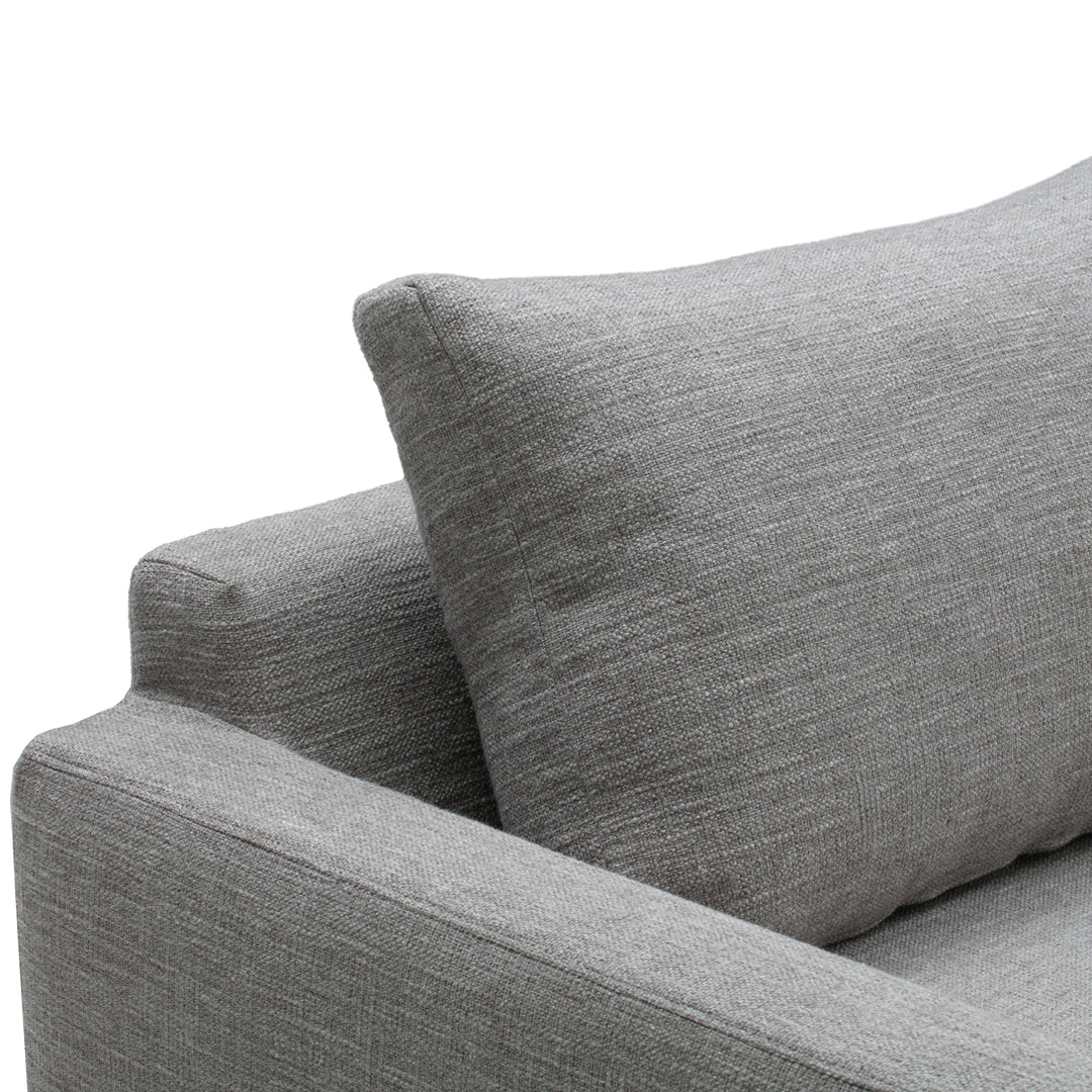 Gray textured fabric sofa with a matching accent pillow, showcasing a modern and minimalist design.