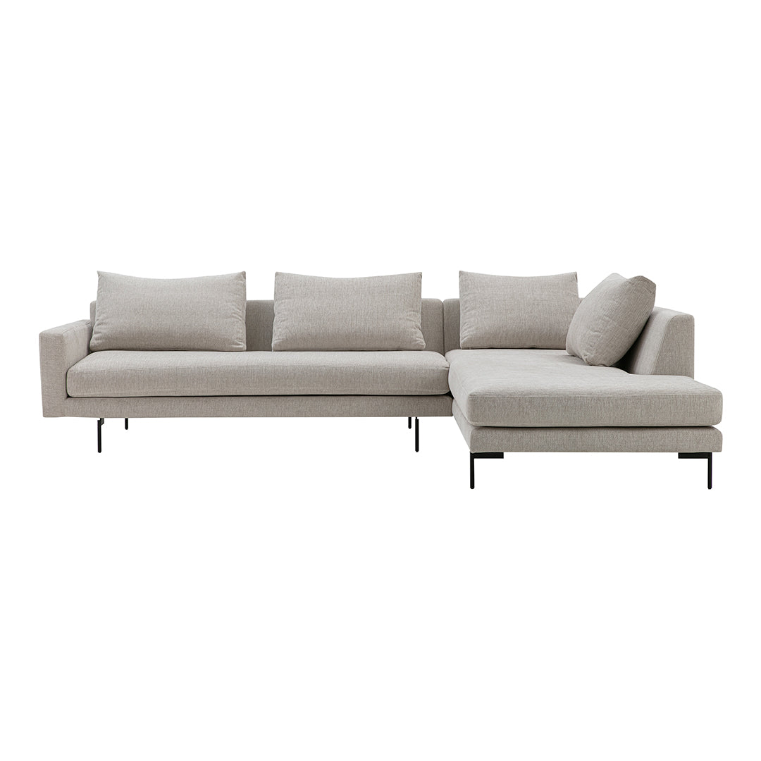 Light beige sectional sofa with a sleek design and soft cushions, featuring clean lines and minimalistic style.