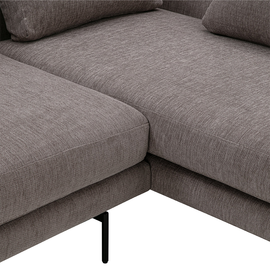 Gray textured fabric sectional sofa corner with clean lines and black metal legs. Perfect for modern living spaces.