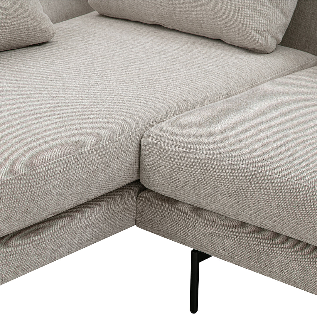 Light gray fabric sectional sofa with a smooth texture and minimalist design. Ideal for modern interiors.