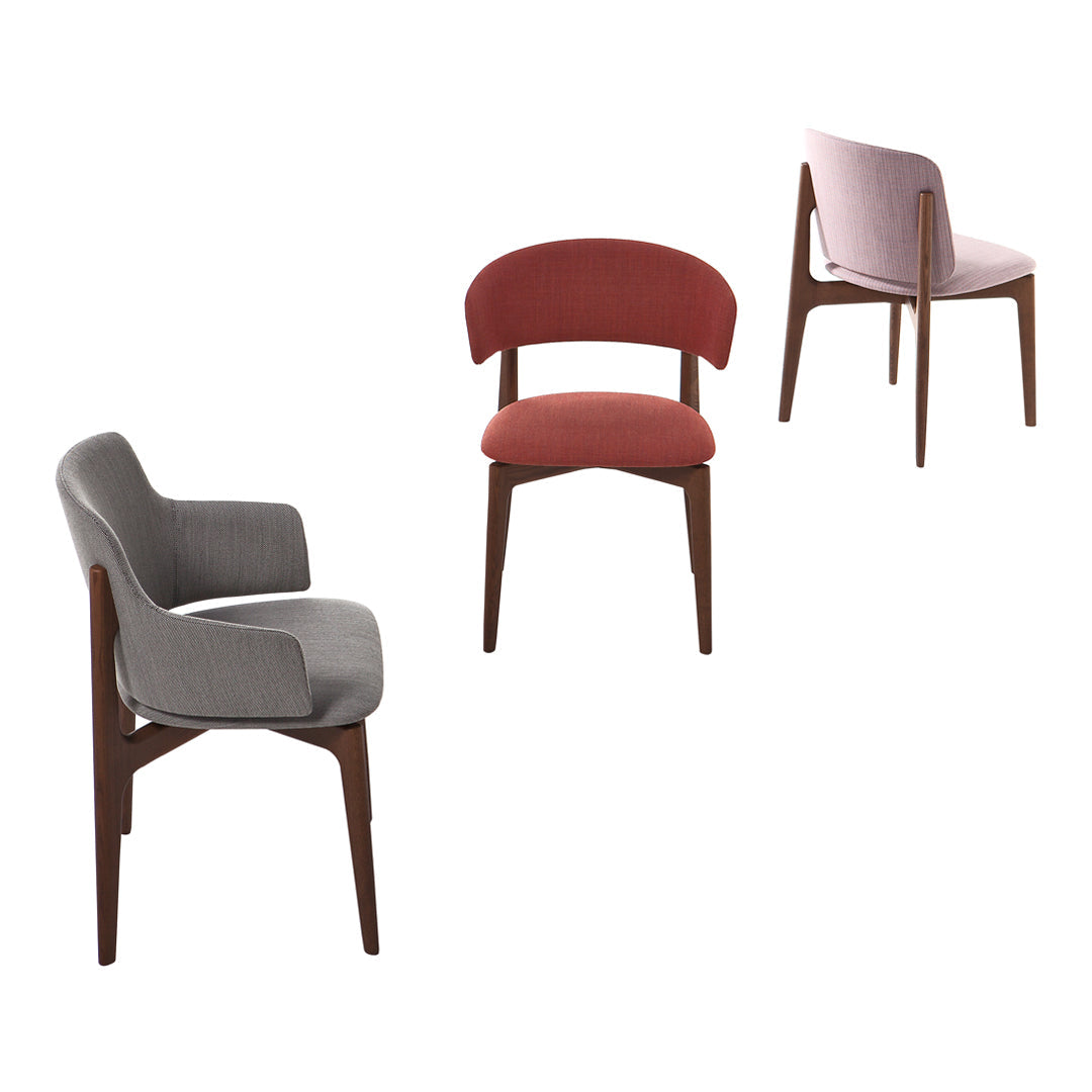 Set of three modern chairs featuring grey, red, and pink upholstery with smooth wood legs. Stylish, contemporary design.