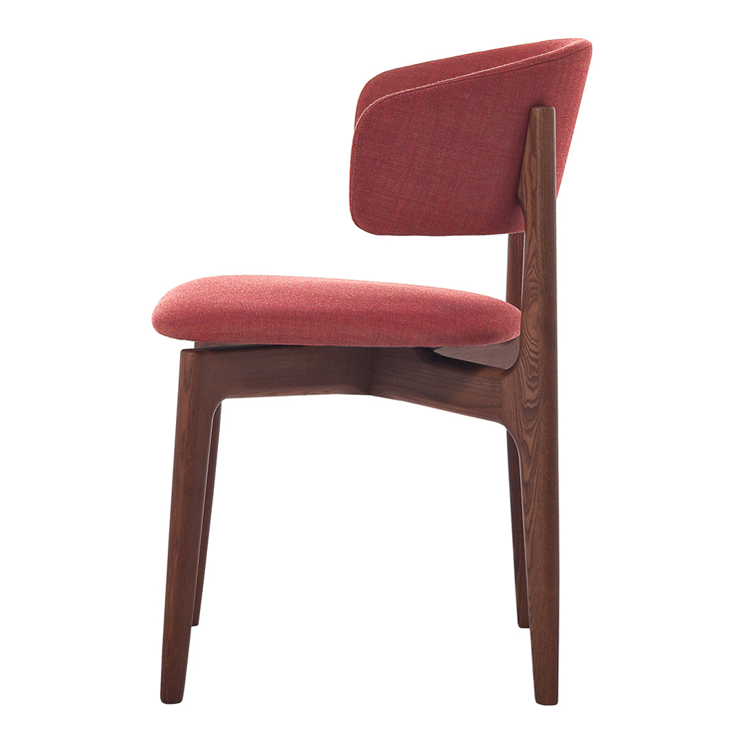 Side view of a modern chair featuring a warm red upholstery and a dark wood frame. Simple, elegant design.