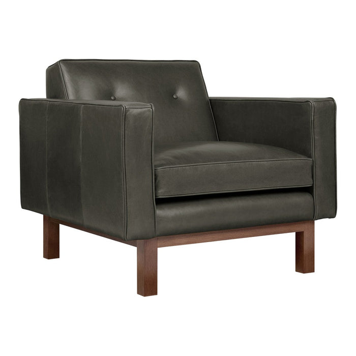 Fashionable dark green leather chair with a smooth finish and subtle button detailing, complemented by a wooden base.