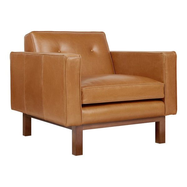 Tan leather armchair with smooth texture and subtle button details, complemented by a warm wood base.