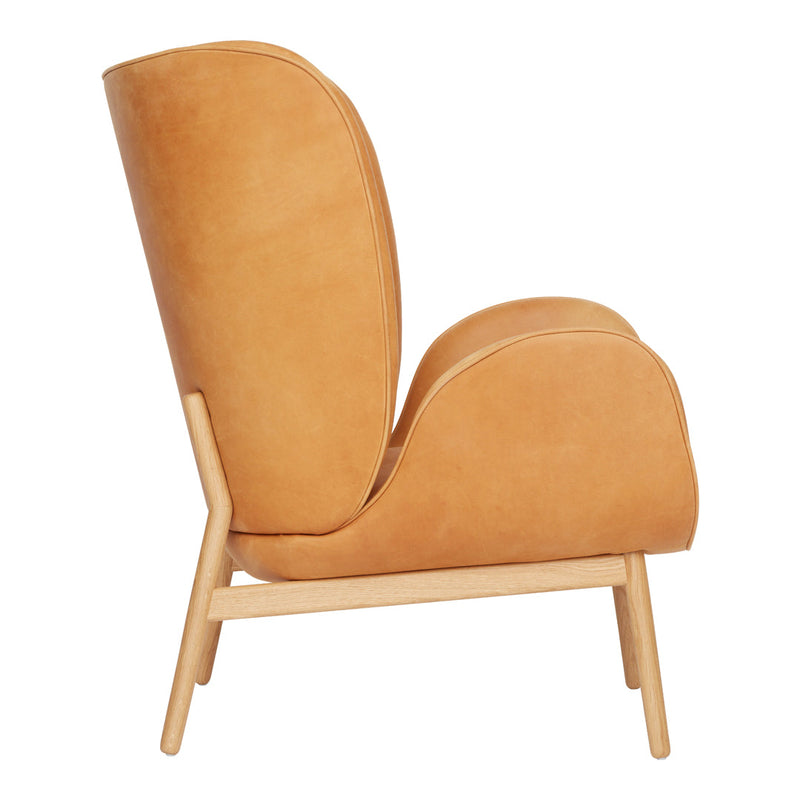 Tan leather chair with smooth, curved design and light wood legs, offering a minimalist, modern aesthetic.