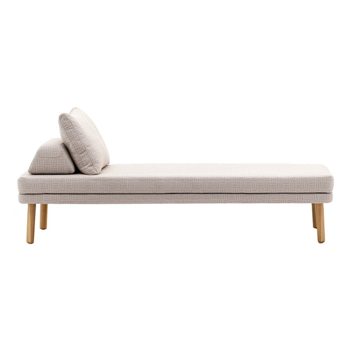 Beige chaise lounge with a smooth texture and contrasting light wood legs, featuring two plush cushions.