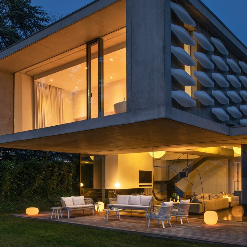 Modern outdoor furniture with a neutral color palette and soft, contrasting lighting accents. Elegant and contemporary design.