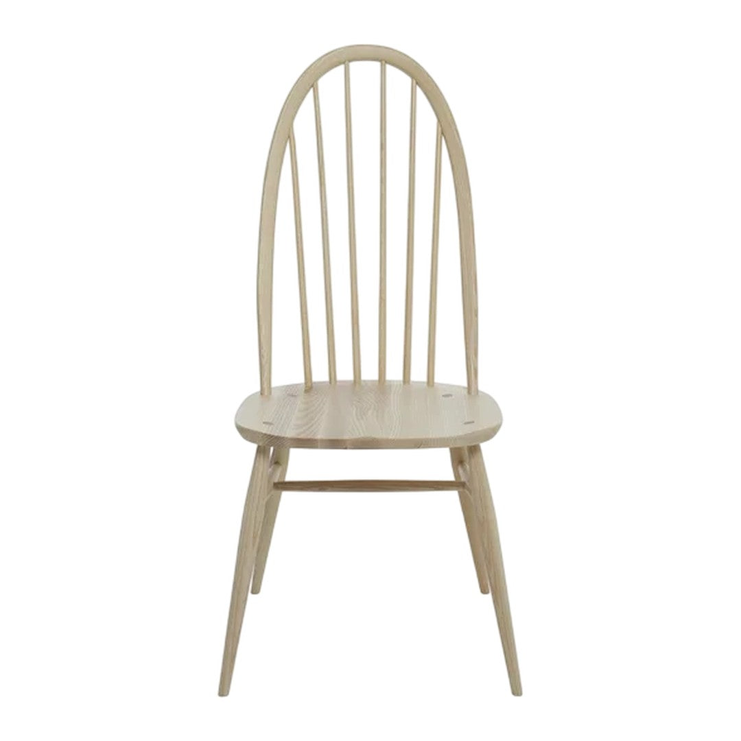 Light natural wood dining chair with a minimalist design featuring vertical slats and tapered legs.