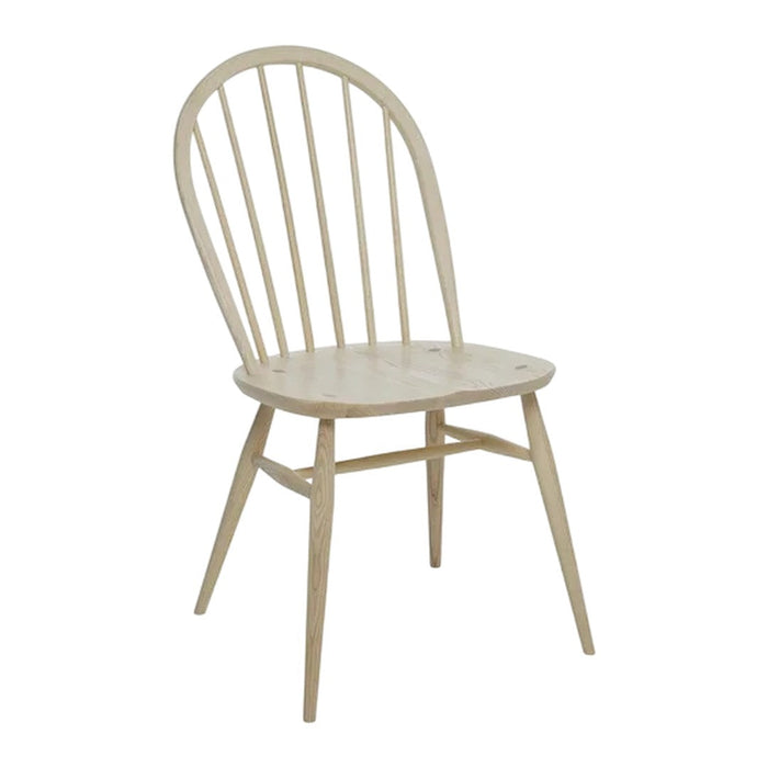 Light natural wood chair with a simple design featuring a curved back and slatted detailing.