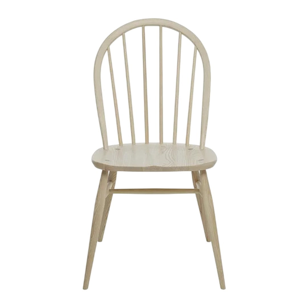 Light wood dining chair with a natural finish and simple, classic spindled back design. Ideal for minimalist decor.