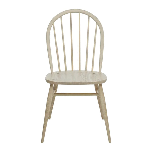 Light wood dining chair with a natural finish and simple, classic spindled back design. Ideal for minimalist decor.