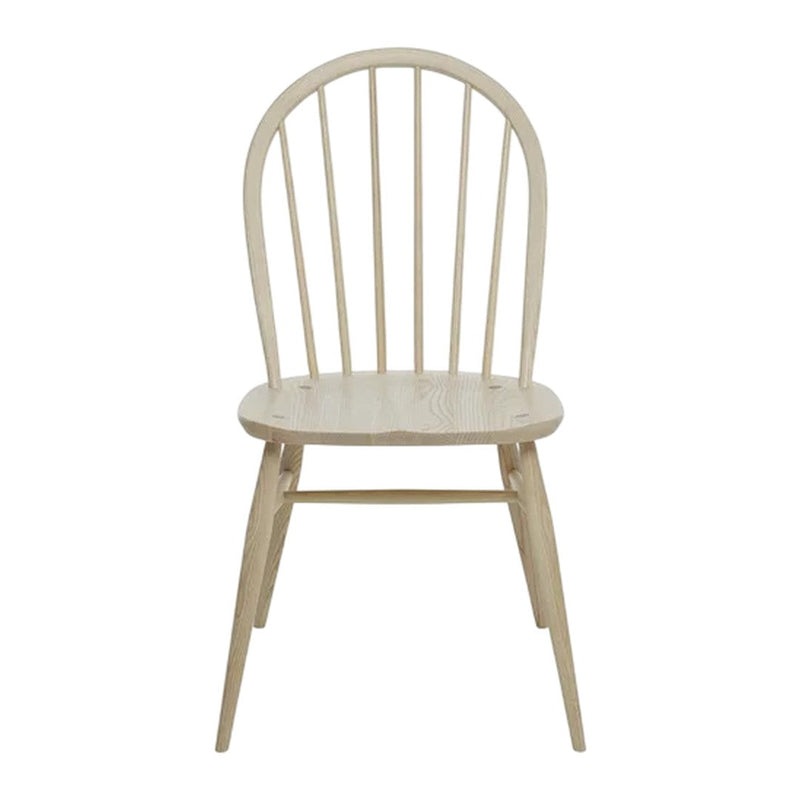 Light wood dining chair with a natural finish and simple, classic spindled back design. Ideal for minimalist decor.
