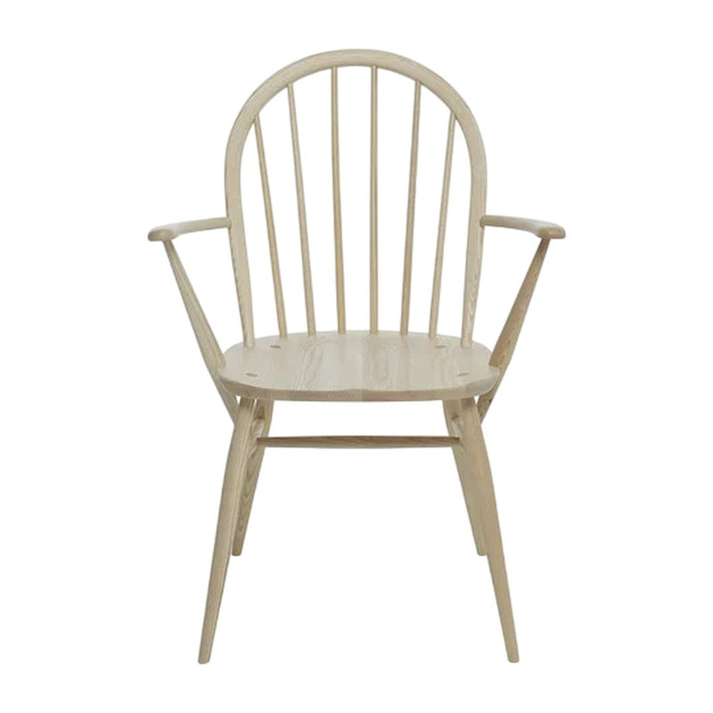 "Light natural wood armchair with a minimalist design and simple vertical slat back."