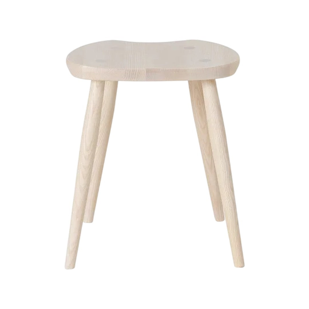 Natural wood stool with a light finish and smooth surface, featuring circular cutouts and tapered legs.