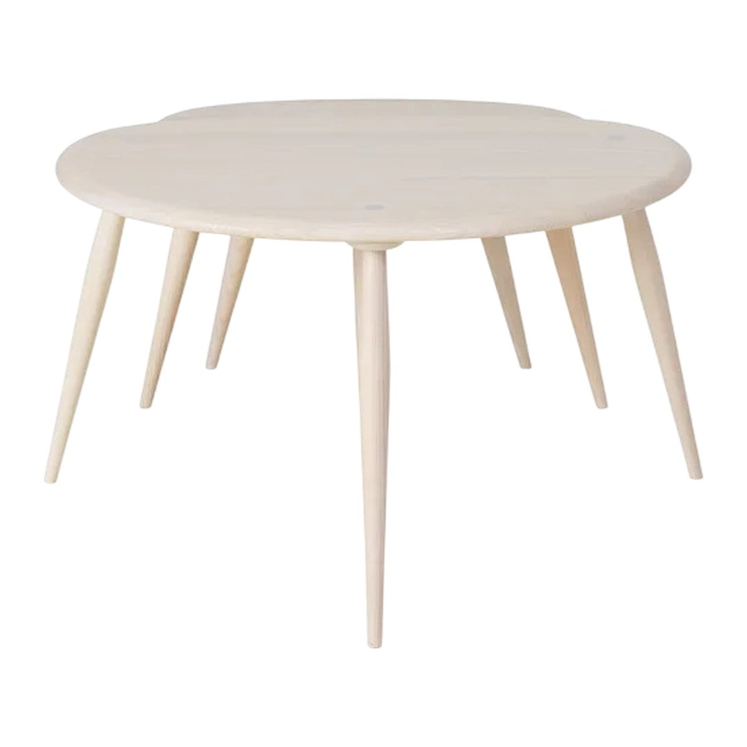 Light wood round table with a smooth finish and slender legs, perfect for minimalist decor.