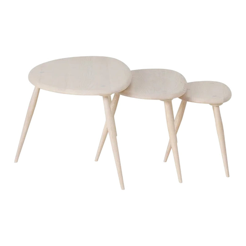 Three wooden nesting tables in a light natural finish with smooth surfaces and tapered legs.