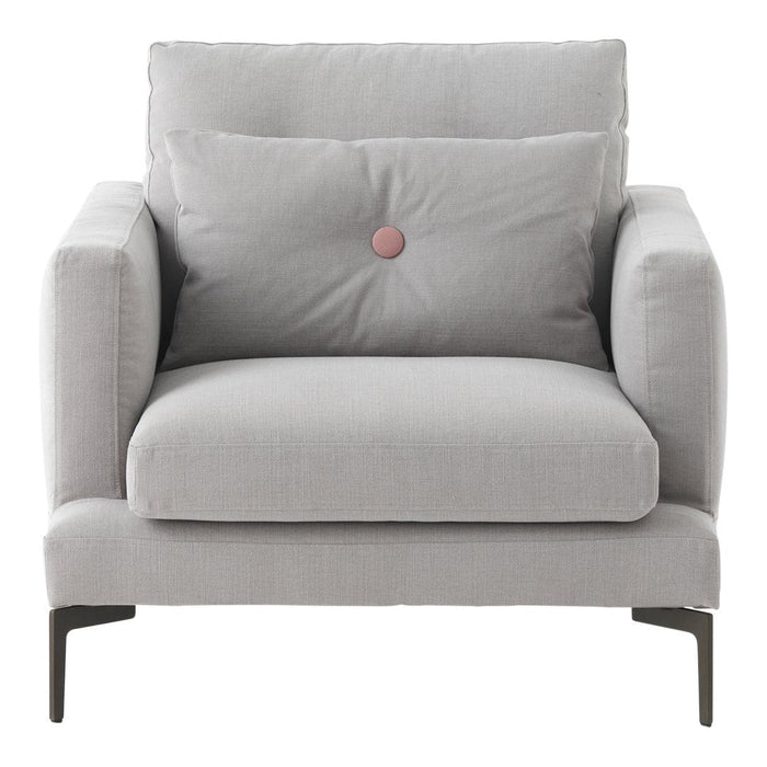 Light gray upholstered armchair with a plush cushion and a decorative pink button. Elegant and modern design.