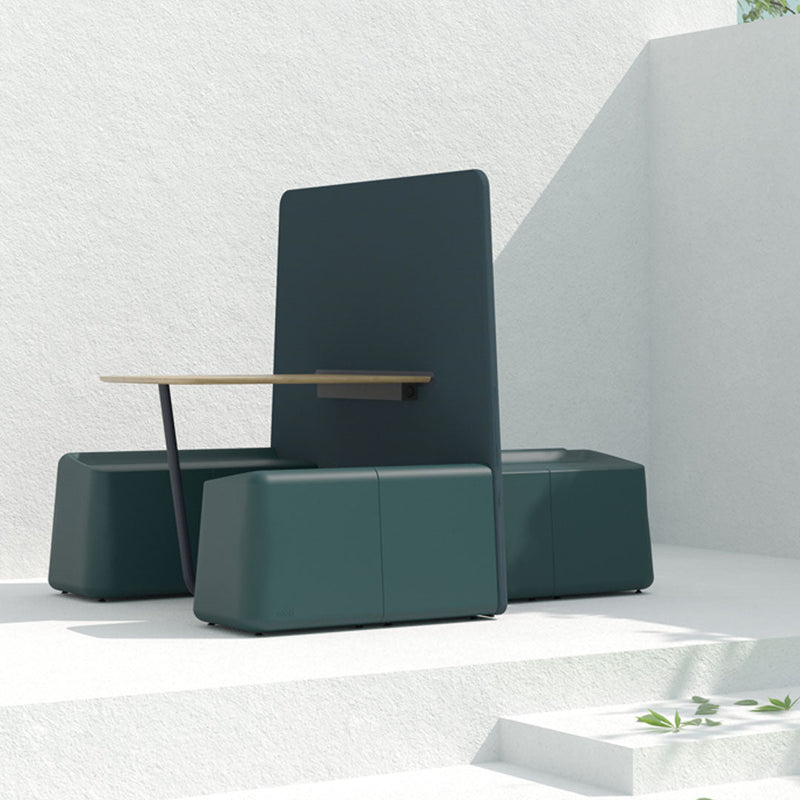 Modern outdoor seating in deep green with smooth, geometric shapes and a natural wood tabletop against a white background.