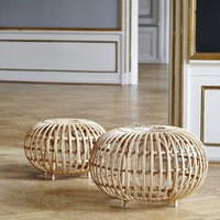 Natural rattan poufs with a circular design, showcasing a light tan color and intricate woven pattern.