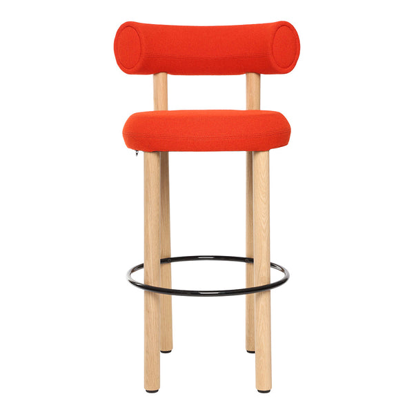 Bright orange upholstered bar stool with round backrest, natural wood legs, and a black metal footrest.