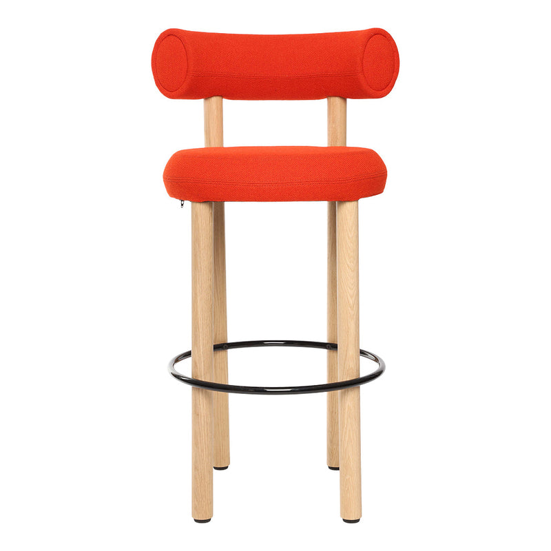 Bright orange upholstered bar stool with round backrest, natural wood legs, and a black metal footrest.