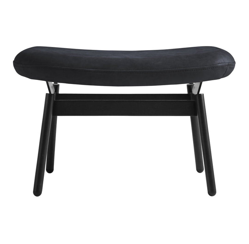 Black upholstered bench with a sleek curved design and sturdy black wooden legs. Modern and minimalist style.