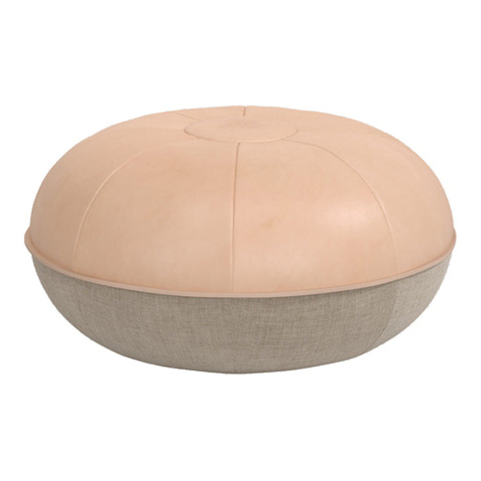 Round pouf in soft beige leather upper with a textured light beige fabric base for a modern, stylish touch.