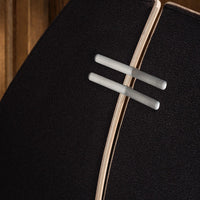 Black fabric texture with subtle wood grain and sleek metal accents for a modern design aesthetic.