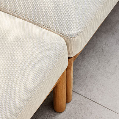 Light beige textured fabric with subtle pattern, complemented by natural wood legs. Modern and elegant design.