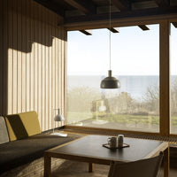 Modern interior with a sofa, coffee table, and large window view.
