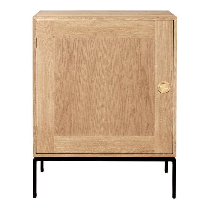 Natural oak finish with a smooth wood grain pattern, accented by a brass knob and black metal legs.