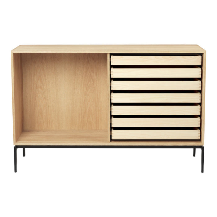 Modern minimalist storage cabinet with a natural wood finish and sleek black metal legs. Features smooth, light-colored drawers.