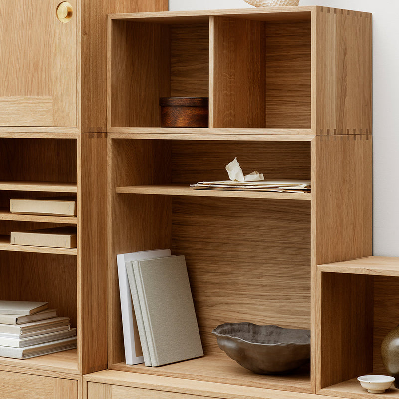 Natural wood finish with light oak tones; minimalist design featuring open shelves and smooth surfaces.