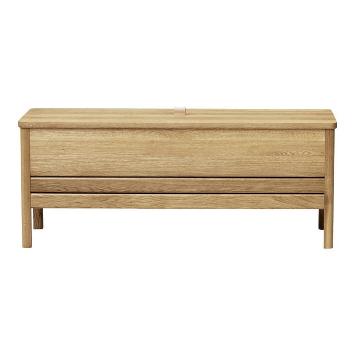 Natural oak storage bench with a smooth finish and subtle wood grain patterns. Ideal for modern home decor.