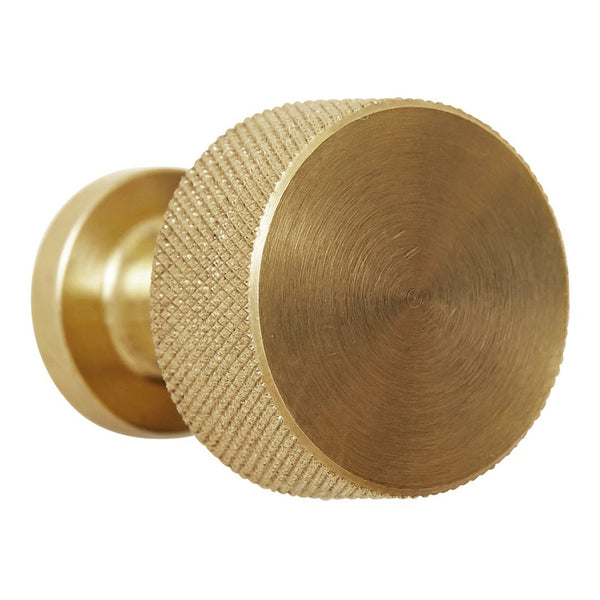 Brushed brass knob with a textured, circular pattern and smooth finish. Ideal for modern home decor.