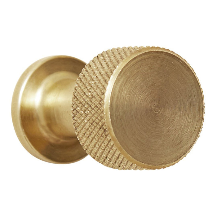 Brushed gold cabinet knob with textured edge and smooth round surface. Perfect for modern home decor.