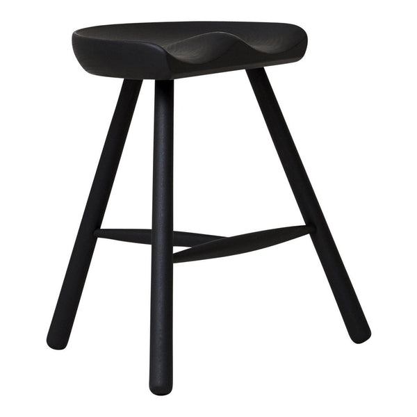 Black wooden stool with a smooth, curved seat and minimalist design, featuring slender, tapered legs.