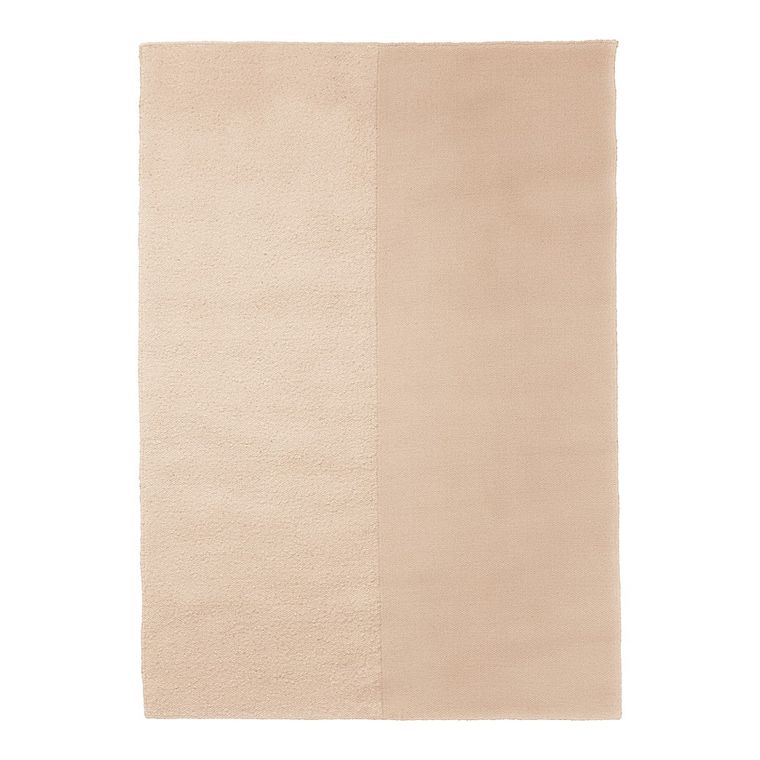 Beige area rug with textured and smooth patterns, showcasing a harmonious blend of light neutral tones.