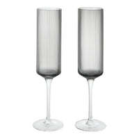 Set of two elegant gray ribbed champagne flutes with clear stems for a modern touch. Perfect for any celebration.