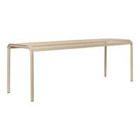 Beige metal bench with a perforated pattern, offering a modern and stylish look for outdoor or indoor spaces.