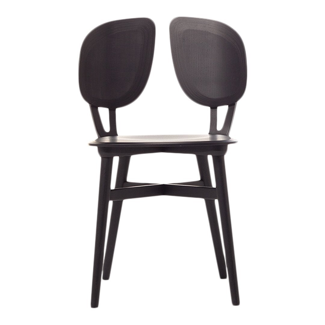 Stylish black chair featuring a minimalist design with curved backs and sleek legs, perfect for modern decor.
