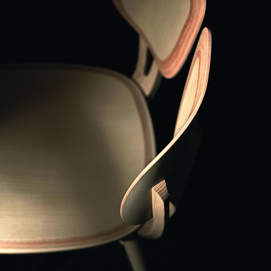 Light wood chair with smooth, natural grain and subtle contrasting curved accents in a dark background.
